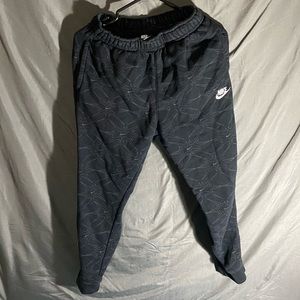 black nike pants with nike signs all over. size small